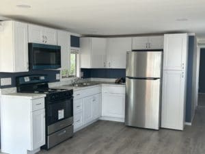 bright Kitchen design with new stove, silver refrigerator, stainless steel sink in Borrego Springs, CA